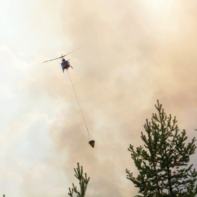 Helikopter släcker skogsbrand